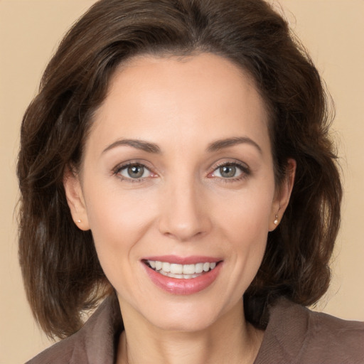 Joyful white young-adult female with medium  brown hair and brown eyes