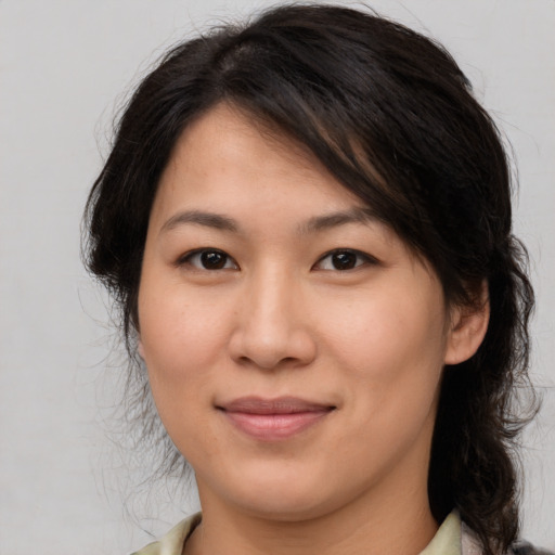 Joyful asian young-adult female with medium  brown hair and brown eyes