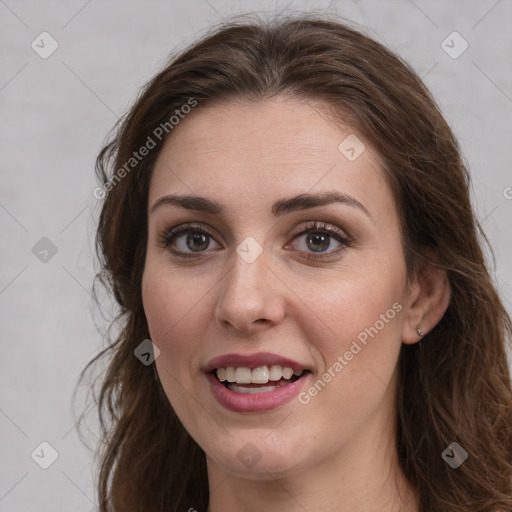 Joyful white young-adult female with long  brown hair and grey eyes