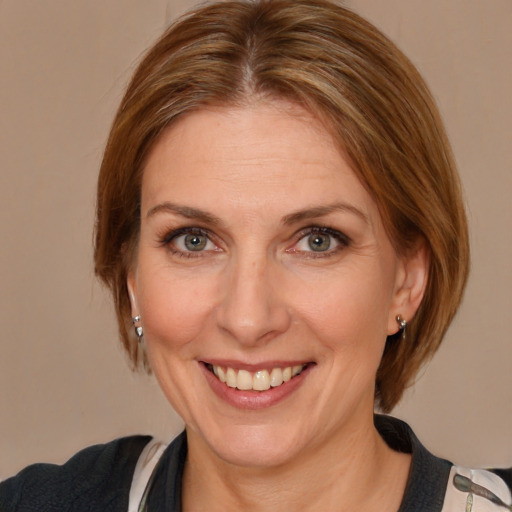 Joyful white adult female with medium  brown hair and blue eyes