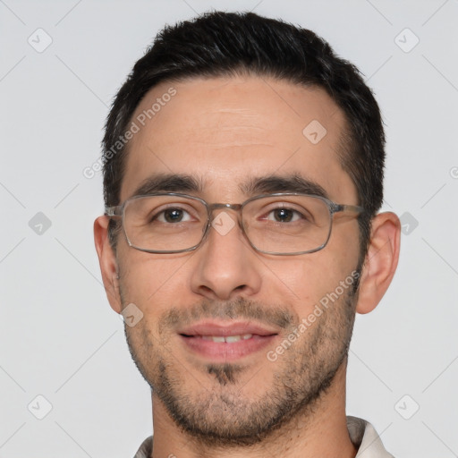 Joyful white adult male with short  black hair and brown eyes