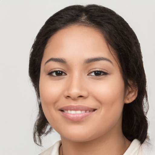 Joyful latino young-adult female with medium  black hair and brown eyes