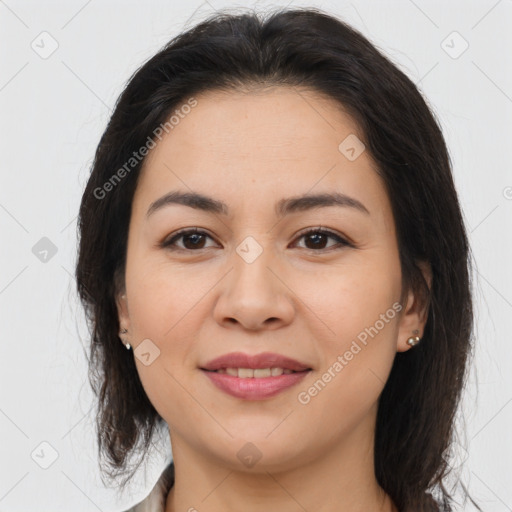 Joyful latino young-adult female with medium  brown hair and brown eyes