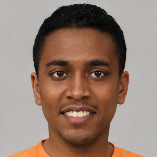 Joyful black young-adult male with short  black hair and brown eyes