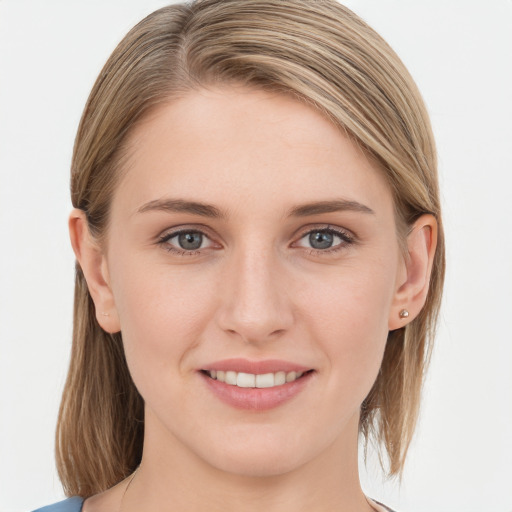 Joyful white young-adult female with medium  brown hair and blue eyes