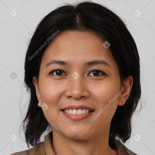 Joyful latino young-adult female with medium  brown hair and brown eyes