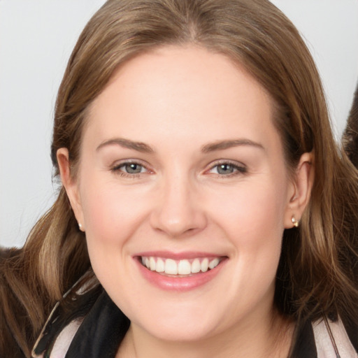 Joyful white young-adult female with long  brown hair and brown eyes