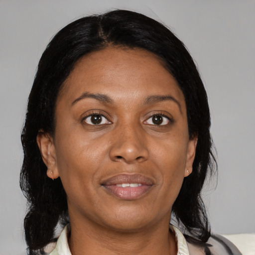 Joyful black adult female with medium  black hair and brown eyes