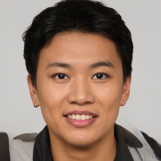Joyful asian young-adult female with short  black hair and brown eyes