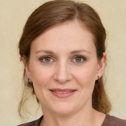 Joyful white young-adult female with medium  brown hair and grey eyes