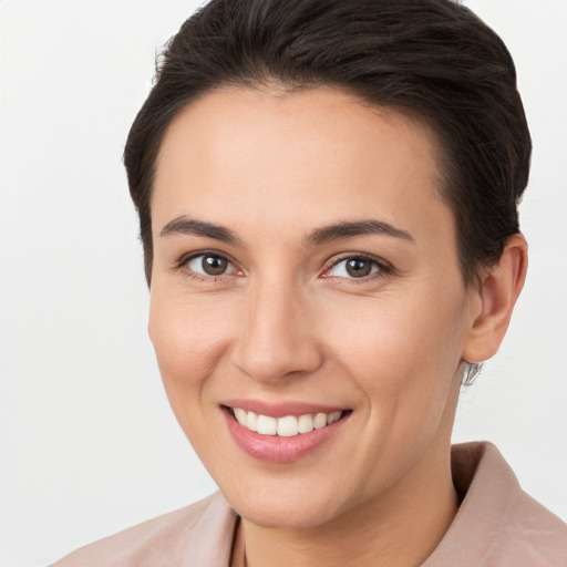 Joyful white young-adult female with short  brown hair and brown eyes