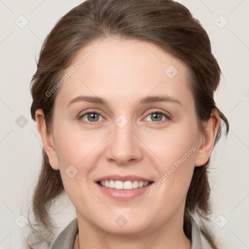 Joyful white young-adult female with medium  brown hair and grey eyes