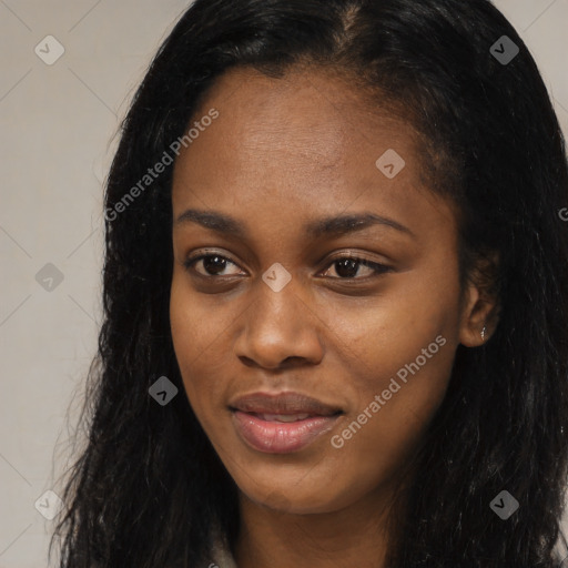 Joyful black young-adult female with long  black hair and brown eyes