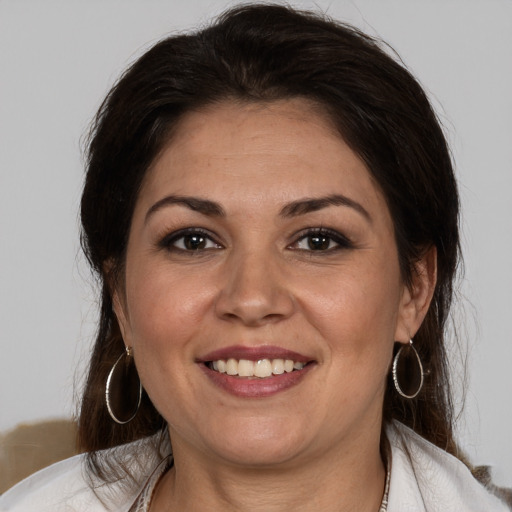 Joyful white adult female with medium  brown hair and brown eyes