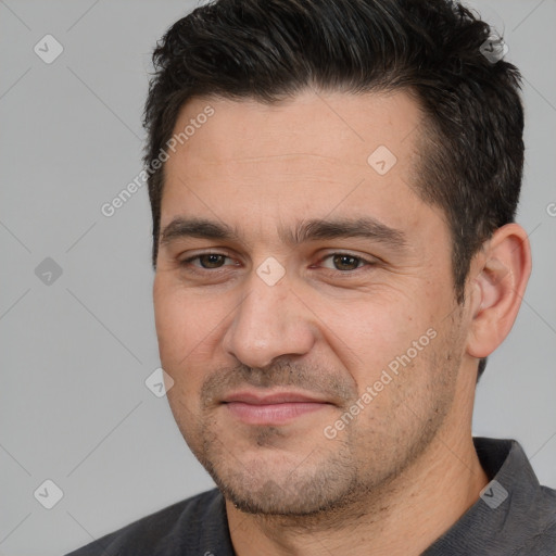 Joyful white adult male with short  black hair and brown eyes