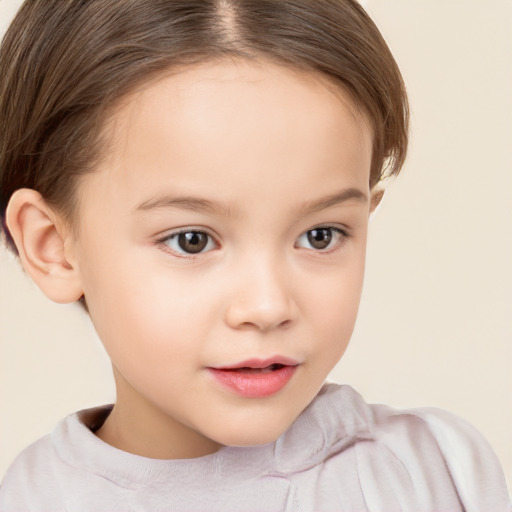 Joyful white child female with short  brown hair and brown eyes