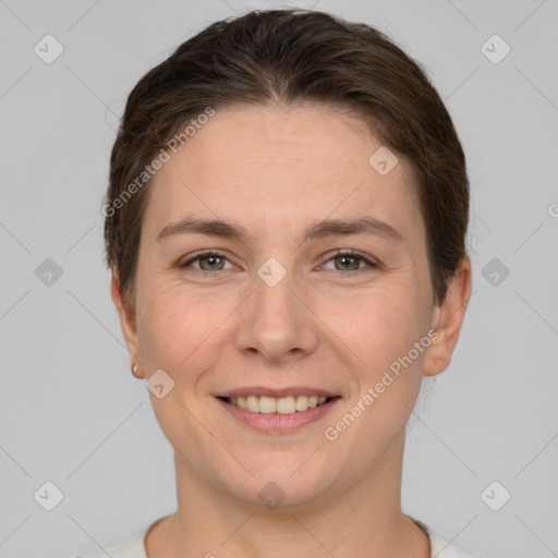 Joyful white young-adult female with short  brown hair and grey eyes