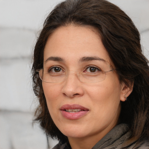 Joyful white adult female with medium  brown hair and brown eyes