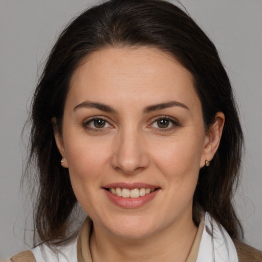 Joyful white young-adult female with medium  brown hair and brown eyes