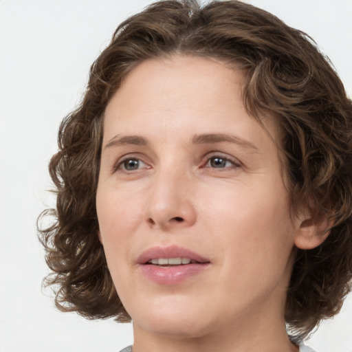 Joyful white young-adult female with medium  brown hair and green eyes