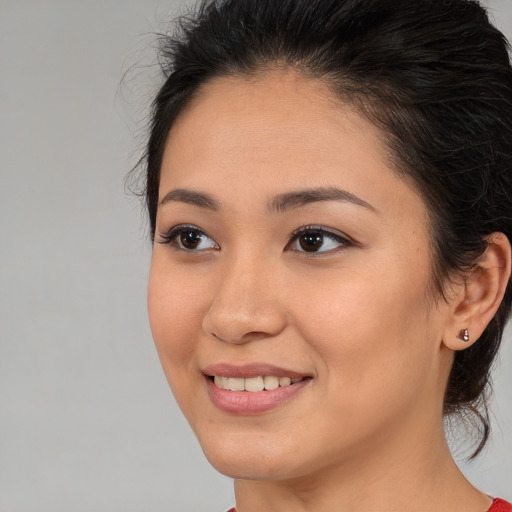 Joyful asian young-adult female with medium  brown hair and brown eyes