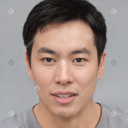 Joyful asian young-adult male with short  black hair and brown eyes