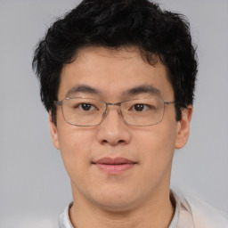 Joyful asian adult male with short  brown hair and brown eyes