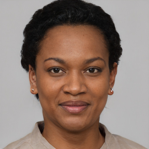 Joyful black young-adult female with short  black hair and brown eyes