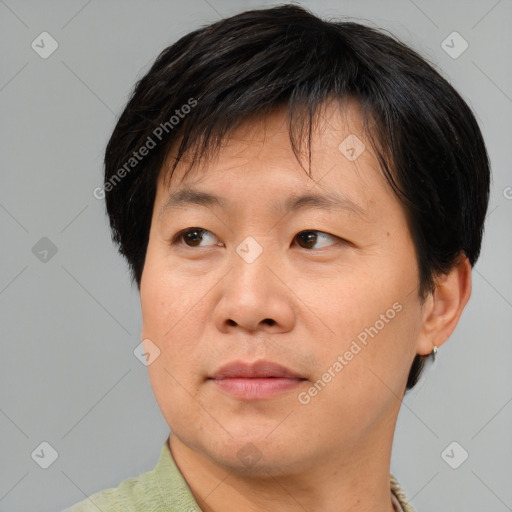 Joyful asian adult male with short  brown hair and brown eyes