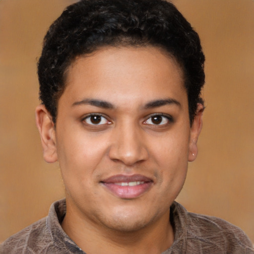 Joyful latino young-adult male with short  brown hair and brown eyes