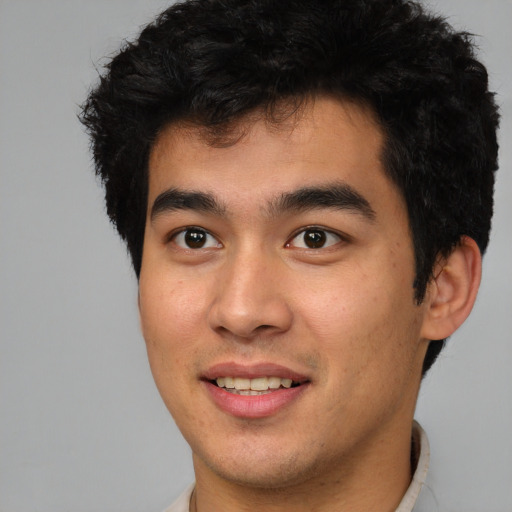 Joyful latino young-adult male with short  brown hair and brown eyes