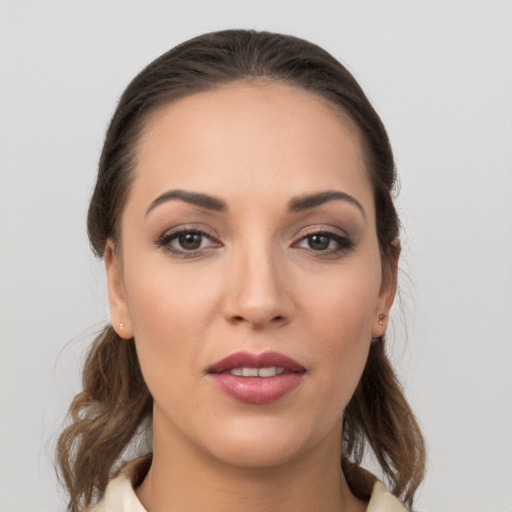 Joyful white young-adult female with medium  brown hair and brown eyes