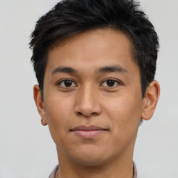 Joyful asian young-adult male with short  brown hair and brown eyes