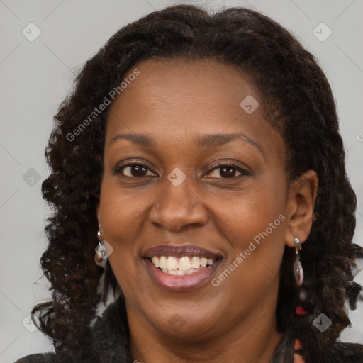 Joyful black adult female with medium  brown hair and brown eyes