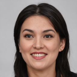 Joyful latino young-adult female with long  brown hair and brown eyes