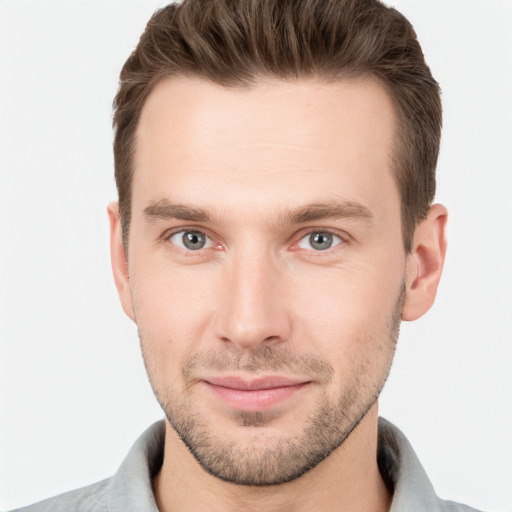 Joyful white young-adult male with short  brown hair and grey eyes