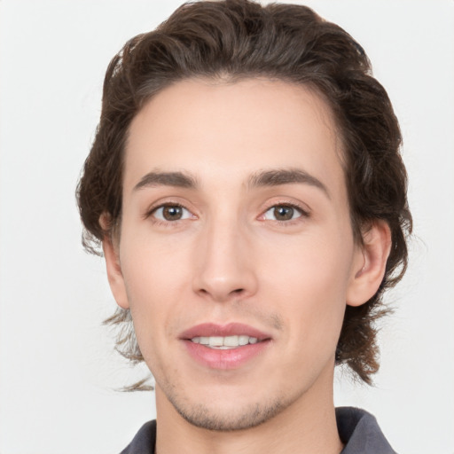 Joyful white young-adult male with medium  brown hair and brown eyes