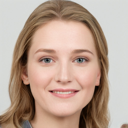 Joyful white young-adult female with long  brown hair and blue eyes