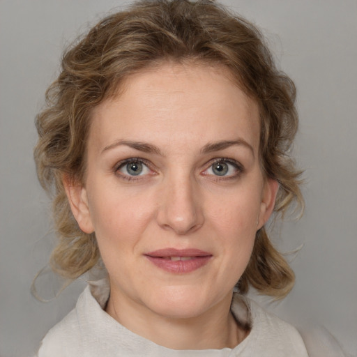 Joyful white young-adult female with medium  brown hair and blue eyes