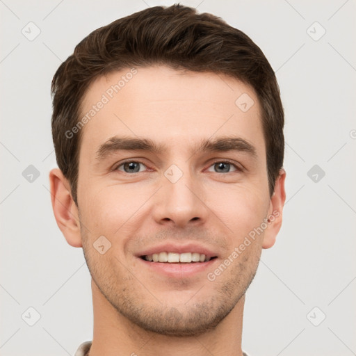 Joyful white young-adult male with short  brown hair and grey eyes