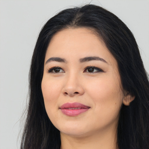 Joyful asian young-adult female with long  black hair and brown eyes