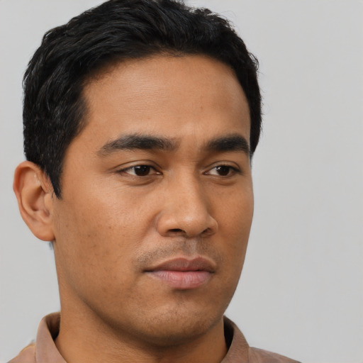 Neutral latino young-adult male with short  black hair and brown eyes