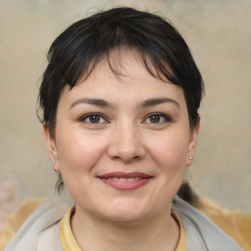 Joyful white young-adult female with medium  brown hair and brown eyes