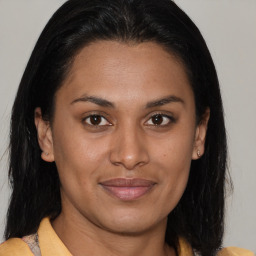 Joyful latino young-adult female with medium  brown hair and brown eyes