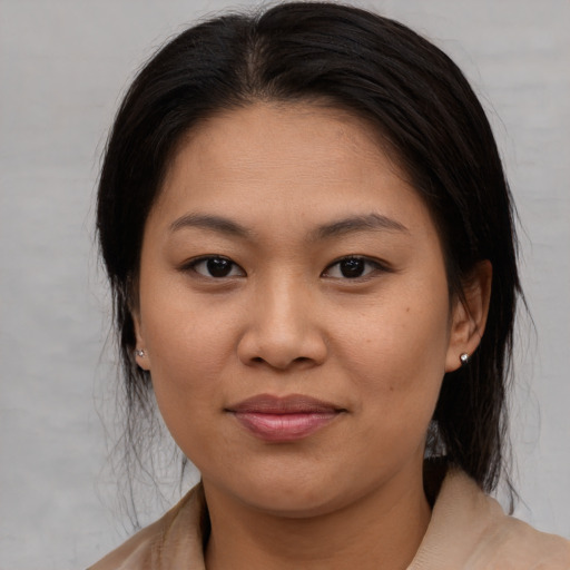 Joyful asian young-adult female with medium  brown hair and brown eyes