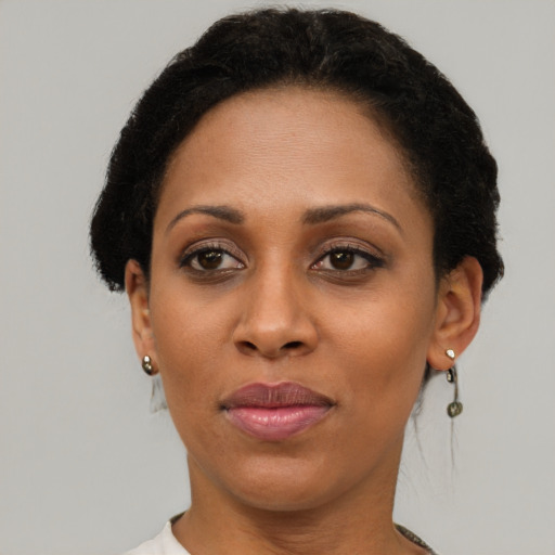 Joyful black adult female with short  brown hair and brown eyes
