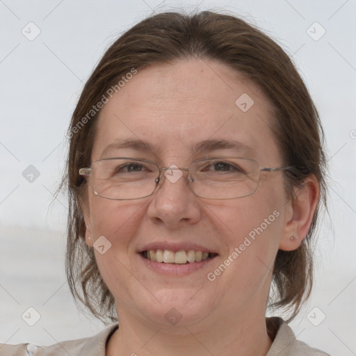 Joyful white adult female with medium  brown hair and grey eyes