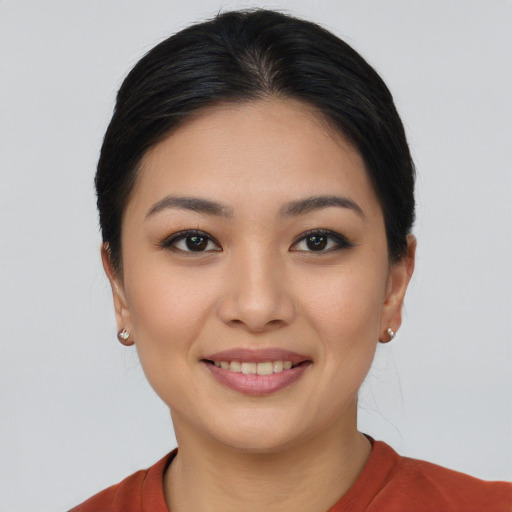 Joyful asian young-adult female with short  black hair and brown eyes