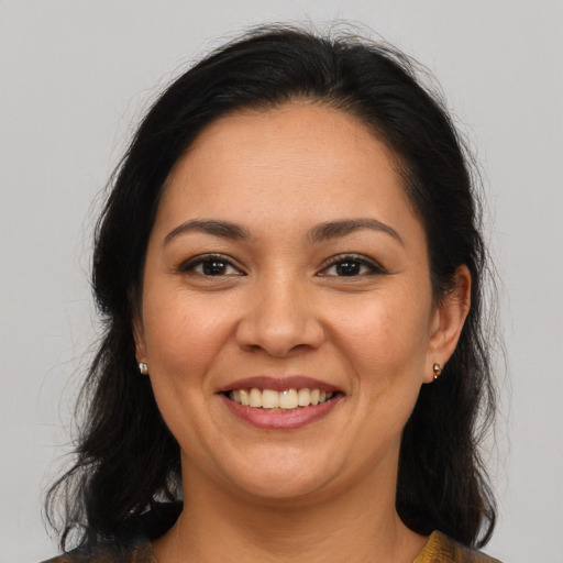 Joyful latino young-adult female with medium  brown hair and brown eyes