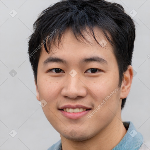 Joyful asian young-adult male with short  black hair and brown eyes